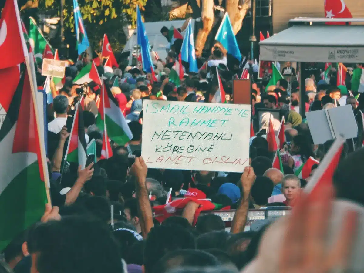 Campaign rally with supporters holding signs, diverse crowd, energetic atmosphere