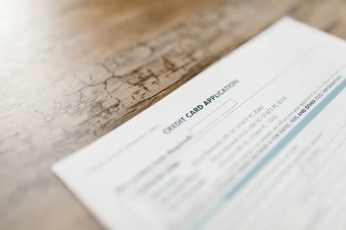 A computer screen displaying a settlement claim form with payment options and deadline information, soft lighting on the interface.