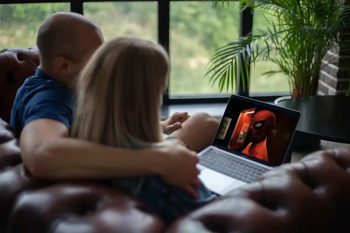 Streaming service selection menu on television screen showing multiple platform options, Netflix interface highlighted with bright colors, remote control nearby