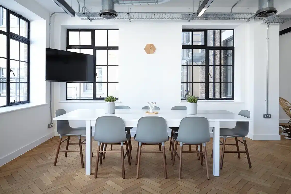 Corporate boardroom with executive portrait on wall, spotlight on empty leather chair, soft ambient lighting, anticipation