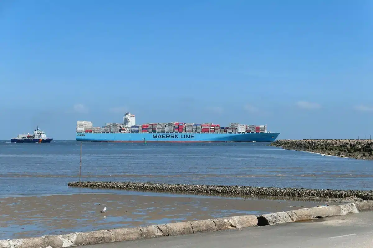 Shipping containers stacked at port with American and Canadian flags, industrial setting