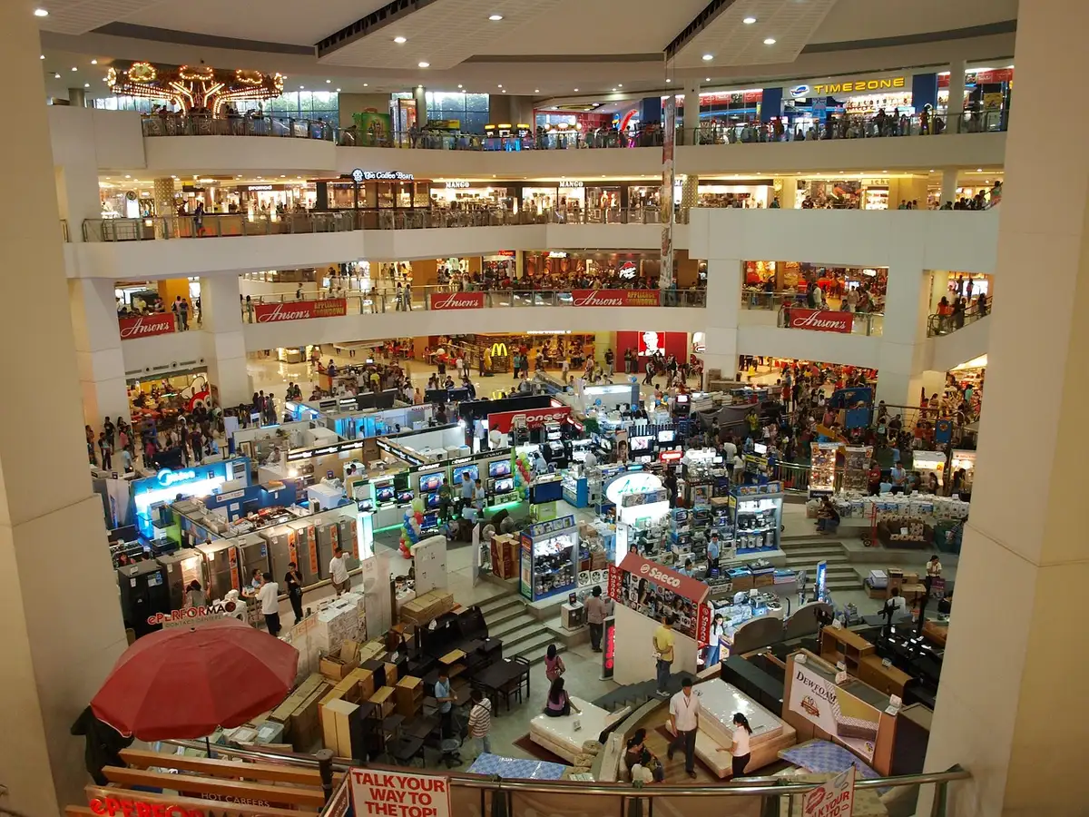 A portfolio of empty retail storefronts in various mall locations, some with closed signage, natural daylight streaming through windows, conveying abandonment
