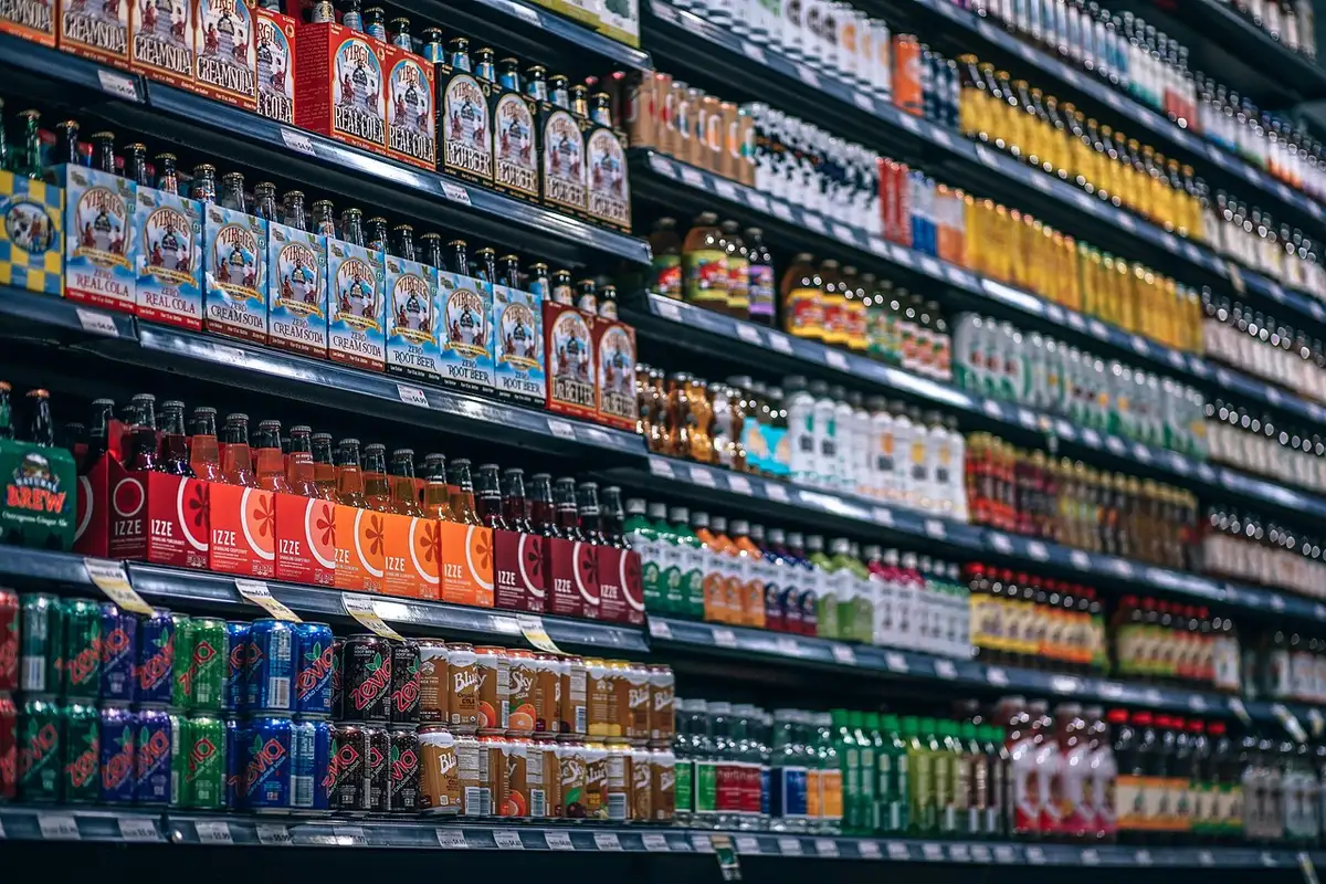 An anonymous, well-lit retail aisle with low shelves displaying plain unbranded holiday items on endcap displays, a small paper price tag reading a generic symbol, faint shoppers in the distance