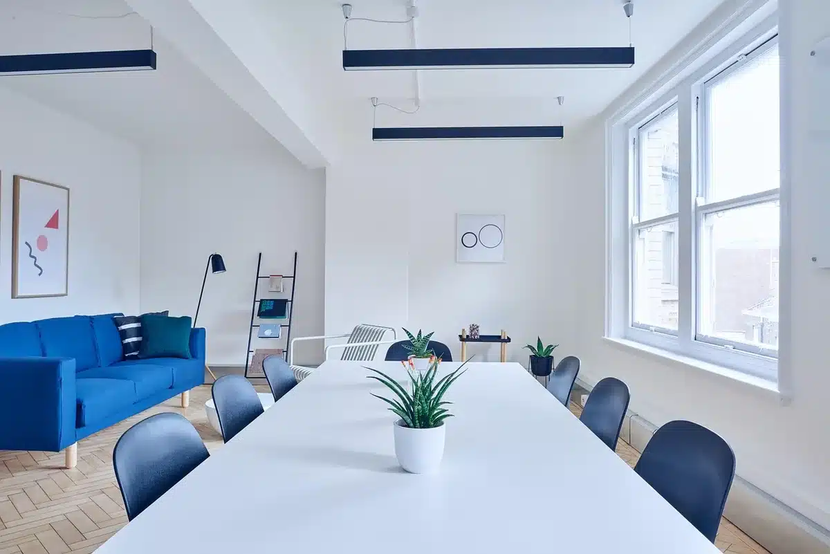 An empty boardroom with a single nameplate reading 'Federal Open Market Committee' removed, a glass of water and paper folder on the table, soft overhead light suggesting a recent meeting