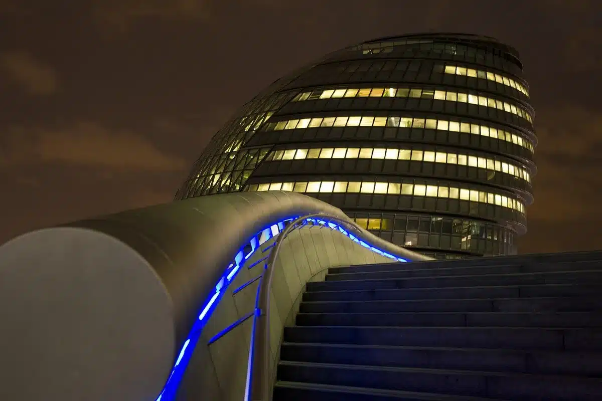 A modern UK city skyline at dusk with government buildings and historic architecture bathed in cool evening light, representing the formal institutional setting where the letter's guidance applies.
