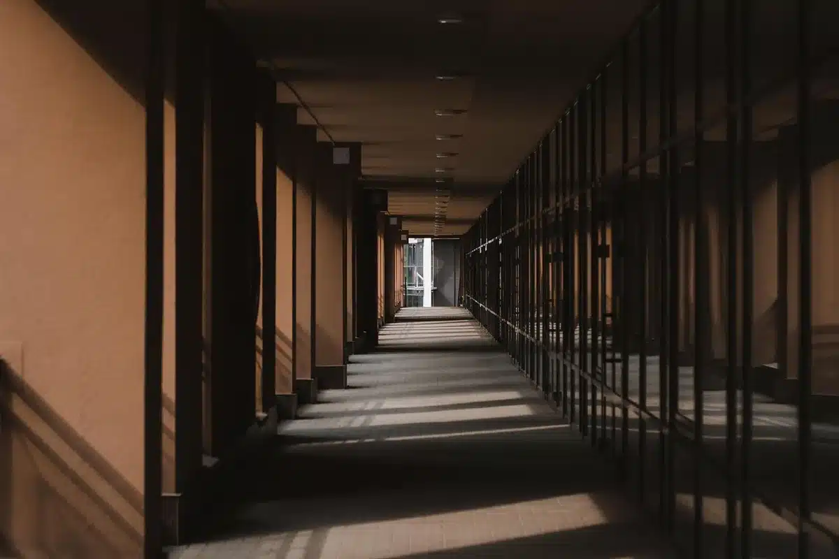 Hospital corridor with modern medical equipment and signage, natural lighting, professional healthcare facility