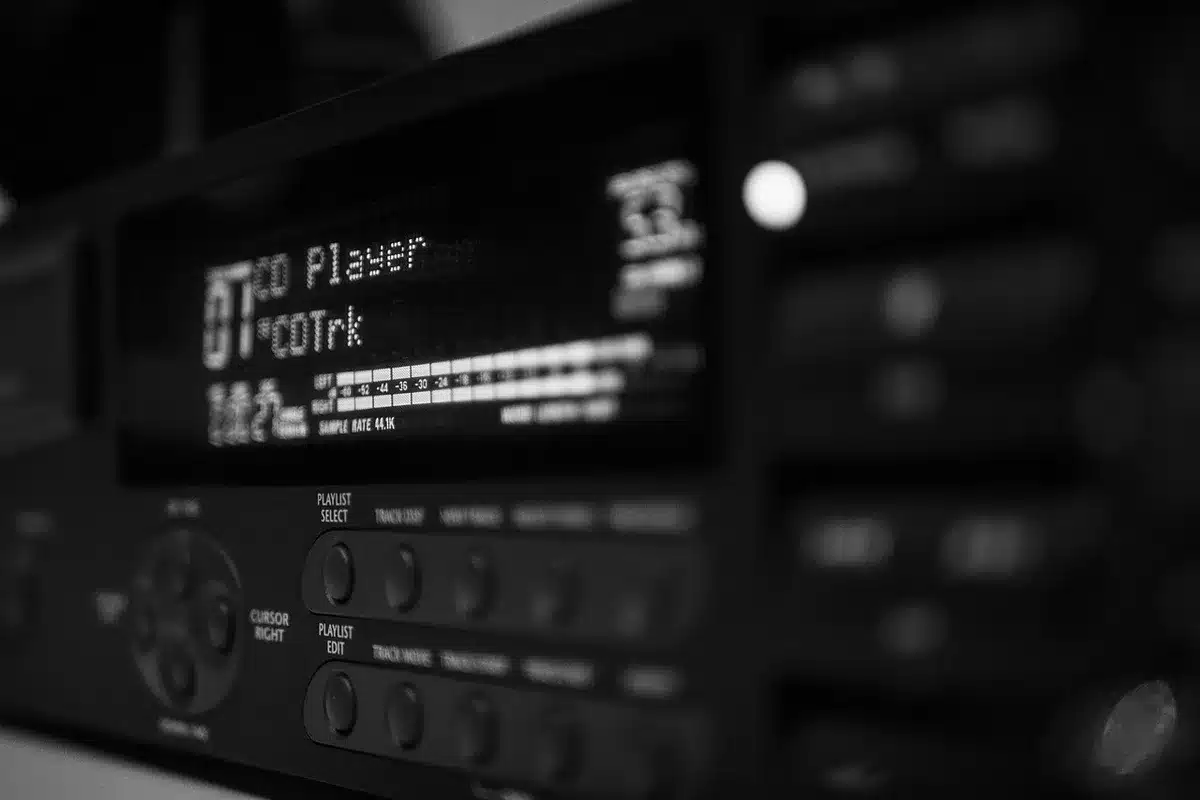A computer screen displaying CD rate comparison tools with various bank names and percentage yields highlighted, a calculator and financial documents scattered on the desk