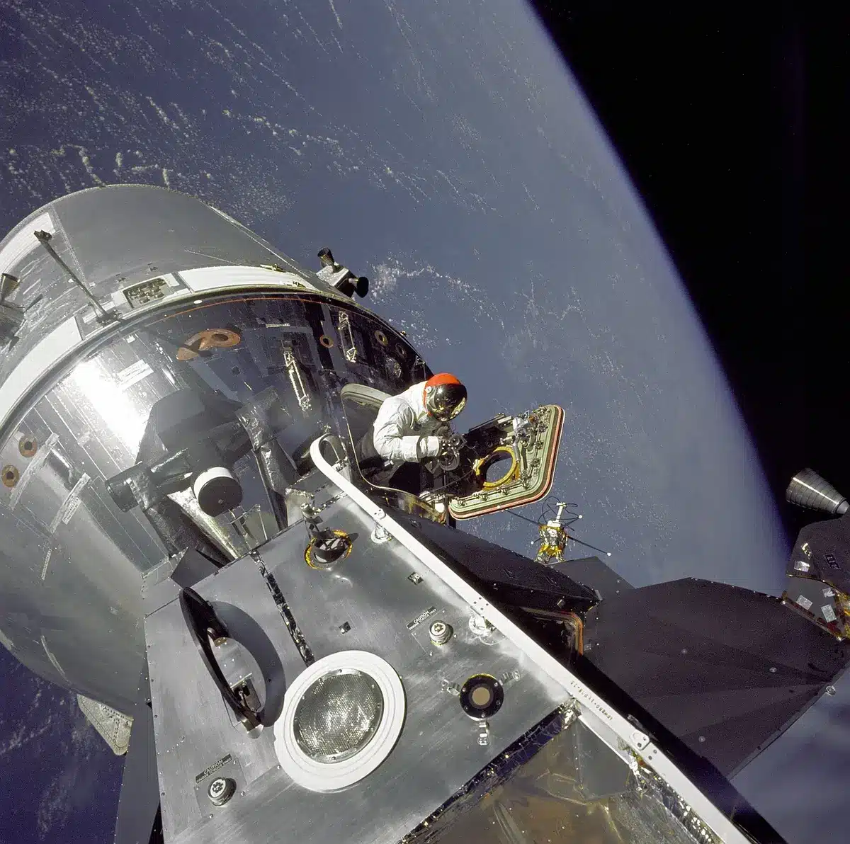 Wide interior view of a generic space station module with equipment racks and an empty workbench, tools and experiments arranged neatly &mdash; evokes daily research operations
