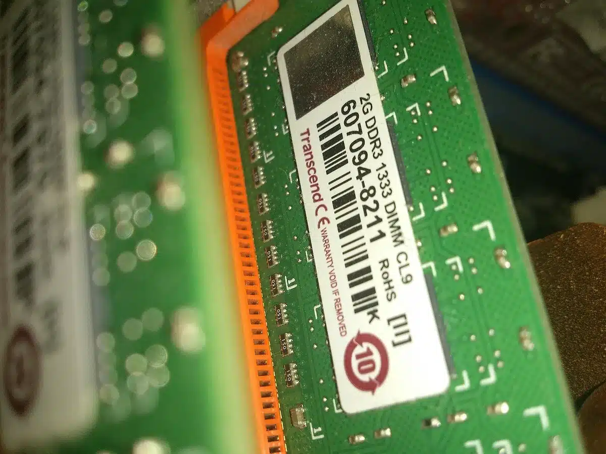 Close-up of an anonymous engineer's hands on a server rack rail, blurred racks behind; hands unbranded and anonymous
