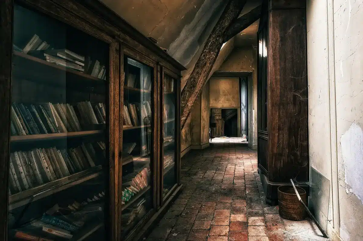 A dim courtroom corridor outside a judge's chambers, empty benches visible, a single set of legal folders left on a table