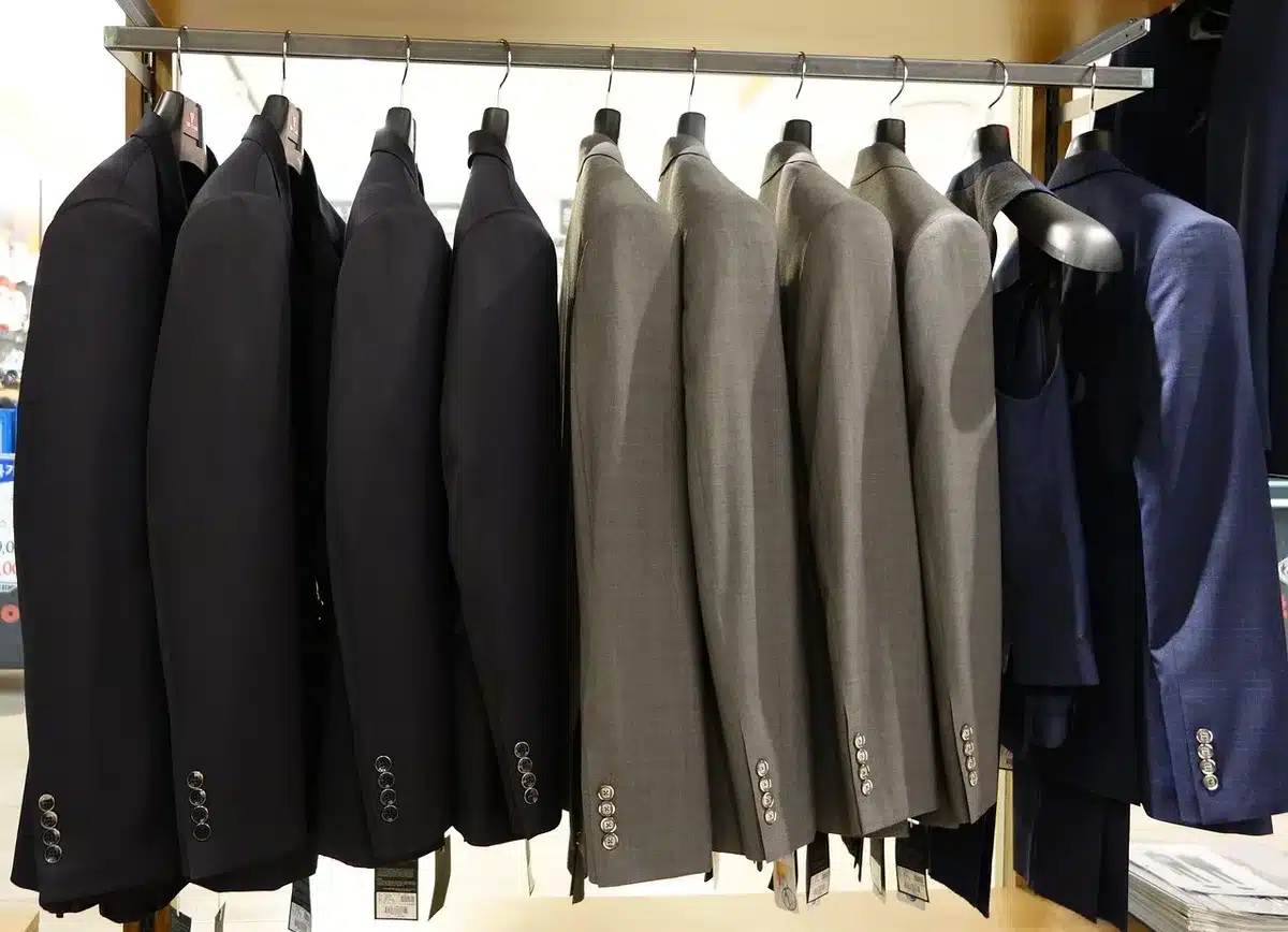 Retail store interior with athletic apparel displays, muted lighting, inventory racks in background