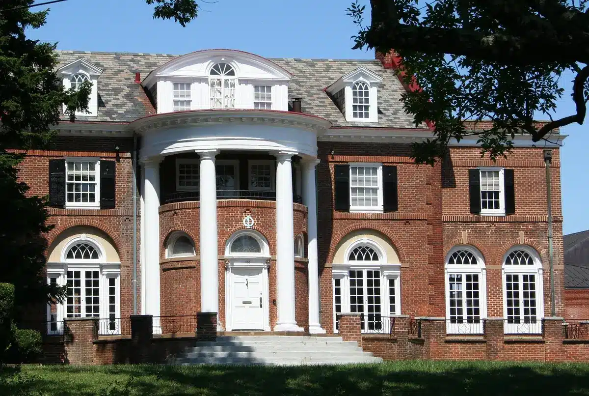 A university campus building with an open courtyard and students walking, symbolizing educational opportunity and institutional support for foster youth