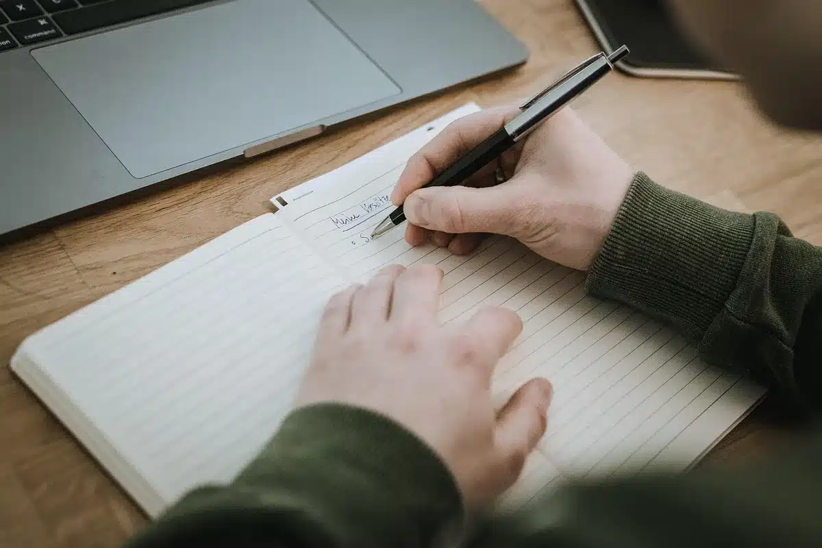 A close-up of scholarship documents and a college acceptance letter on a desk with a pen, representing educational opportunity and financial support