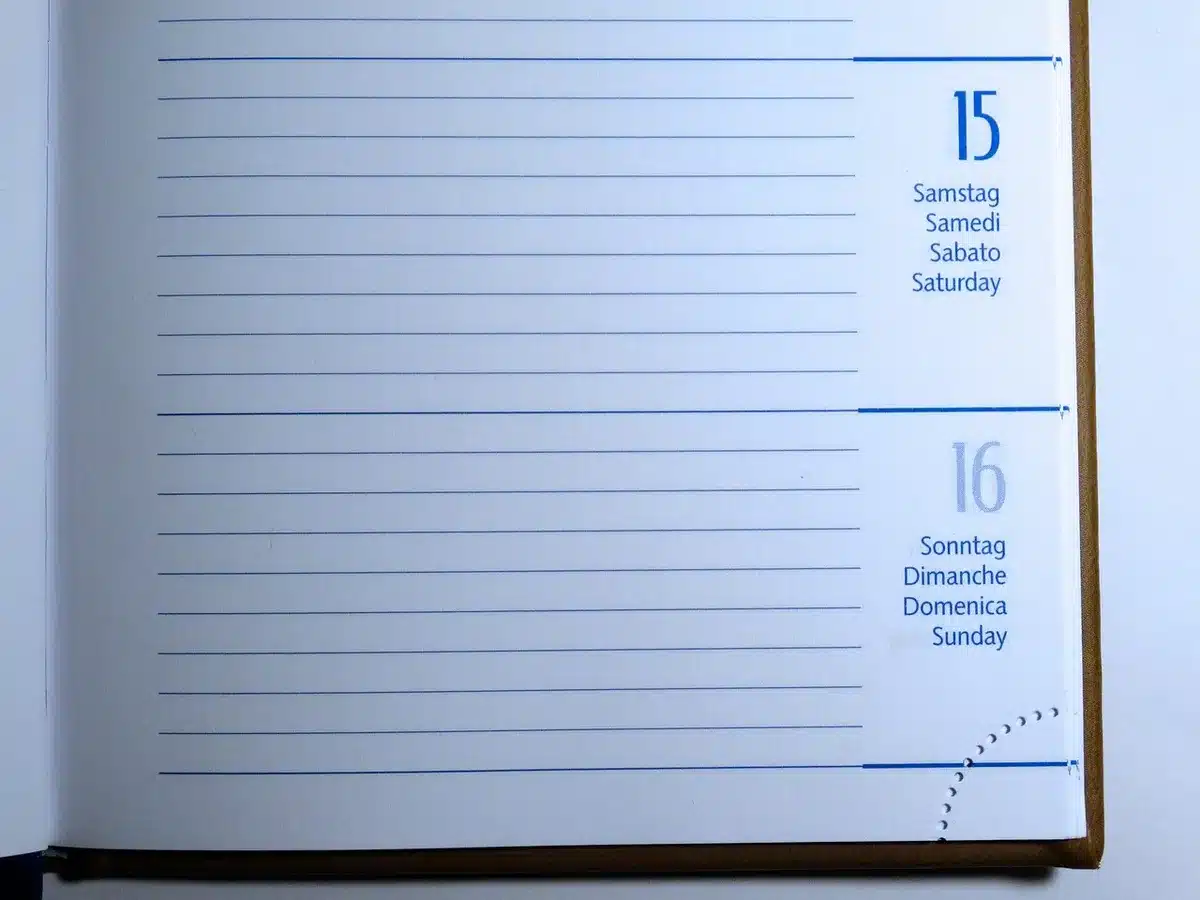 A deserted trading desk with a single printed sheet showing a generic dividend calendar entry and an anonymous hand pointing at the date