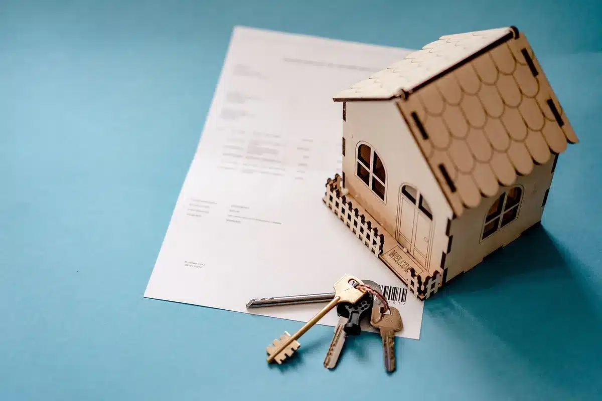 A homeowner reviewing mortgage documents at a desk with a calculator and pen, papers showing loan details and payment schedules spread out, soft indoor lighting, focused and contemplative mood