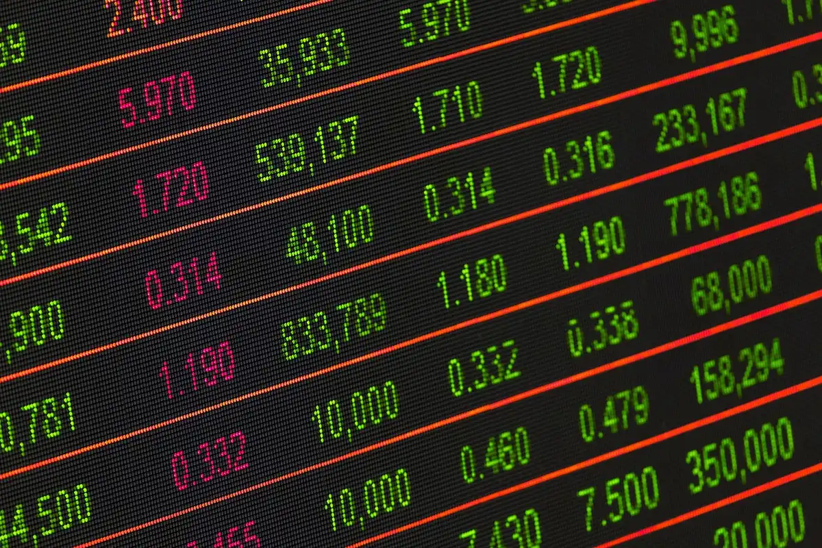 A stock market ticker display showing rising yields and interest rate data on a dark blue screen with red numbers