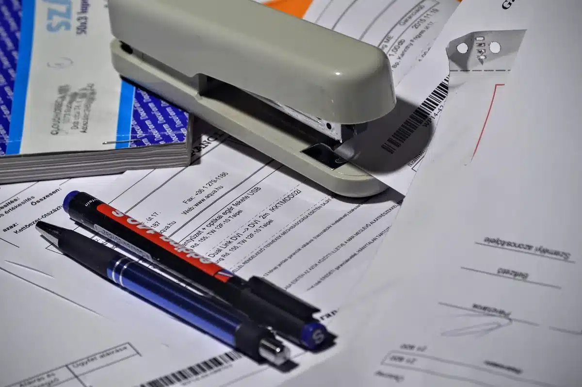 A mortgage application form on a desk with a calculator and pen, soft natural light, papers slightly scattered, suggesting financial planning and paperwork