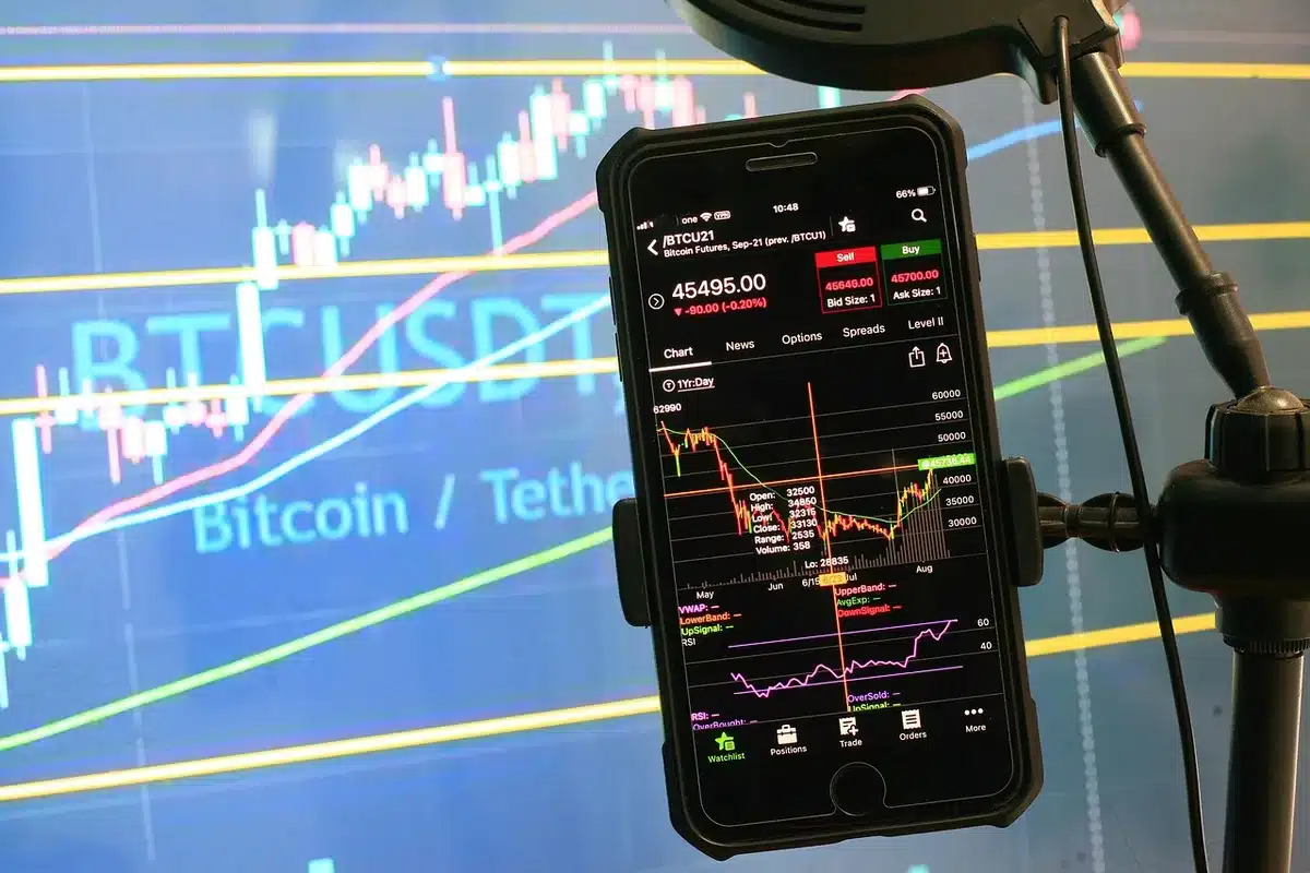 A stock market trading floor with multiple screens displaying green price indicators and rising charts, traders focused on monitors, fluorescent lights reflecting off glass panels, optimistic energy.