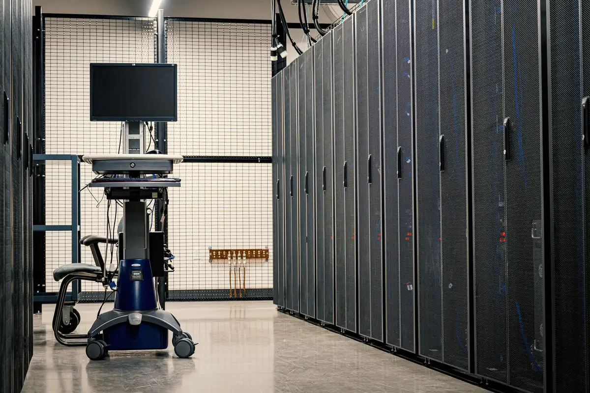 A symbolic lone server rack in a dimly lit room with a single warning light glowing, no logos or people, suggesting a data-center issue