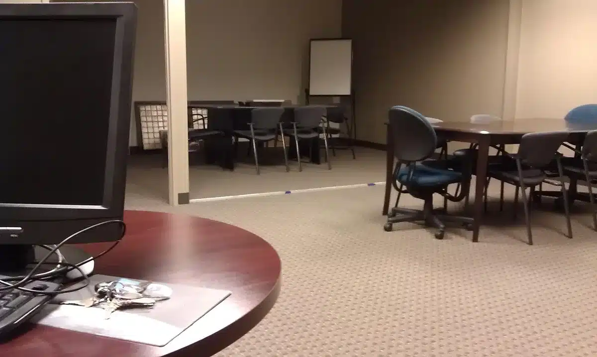 empty war room table with a single file folder and an unbranded four-star insignia placeholder on the table