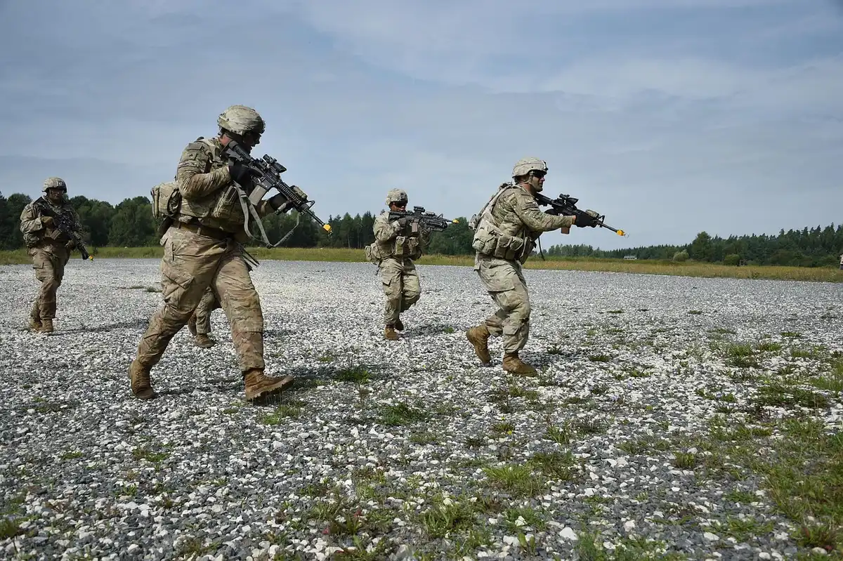 An anonymous squad of soldiers in silhouette doing calisthenics under bright gym lights, emphasis on physical fitness and posture