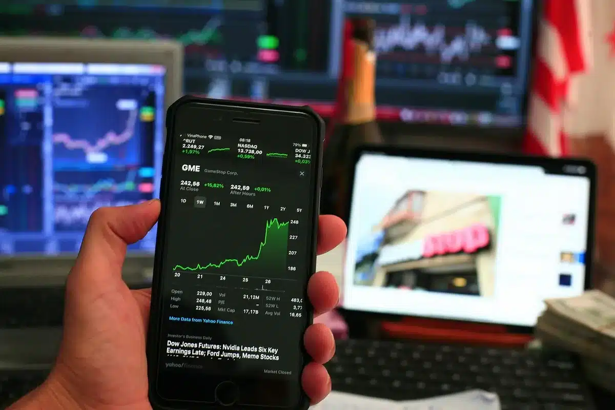 An anonymous glowing wall of market screens showing indexes and price lines, no logos or faces, a single empty chair in front &mdash; traders watching inflation data arrive