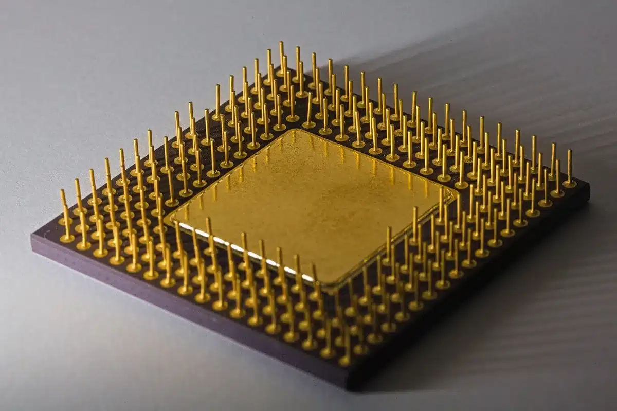 an anonymous close-up of three generic computer chips and a stack of plain index fund prospectuses, no logos visible