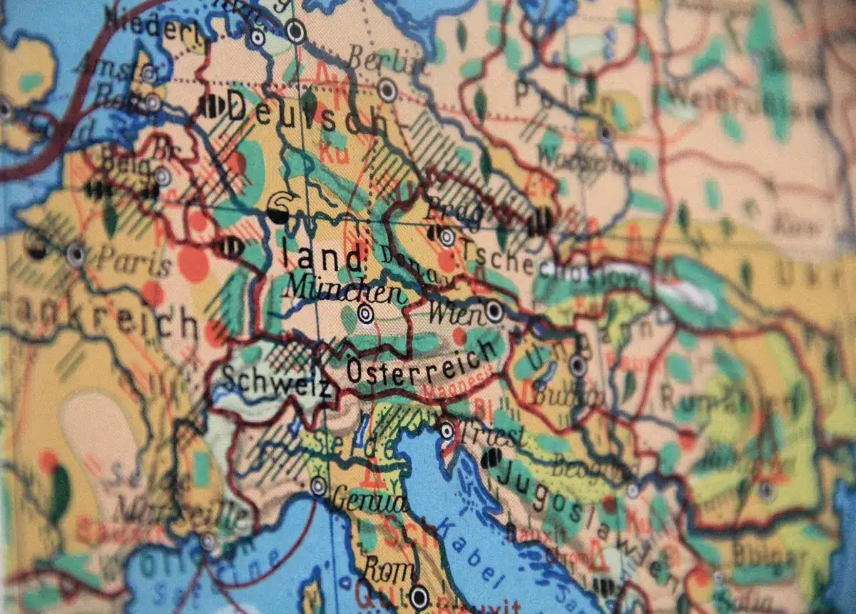 A map of Eastern Europe with Moscow and NATO member states marked, a red line showing the border, morning light streaming across the paper, a pen resting on the table.
