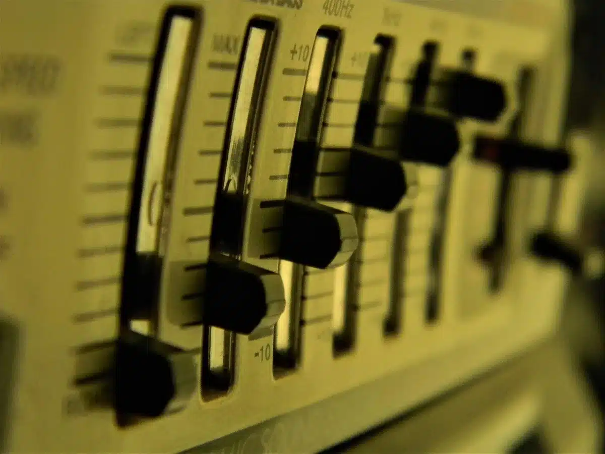 A desk with a turned-off console, a single pair of anonymous headphones resting on the fader board, and a small notepad left open &mdash; quiet studio aftermath suggesting change