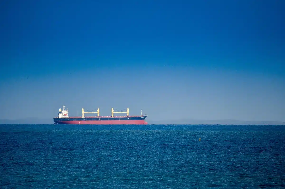 Three Iranian oil tankers engulfed in smoke and flame after precision strikes, dark plumes rising from damaged hulls against blue water, military vessels in the distance, chaos and destruction