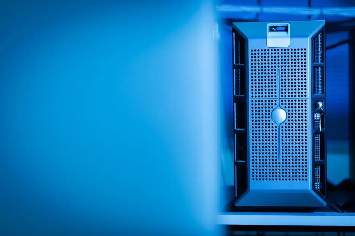 anonymous server room with racks of unbranded hardware, a lone technician silhouette adjusting a cable under cool blue lights