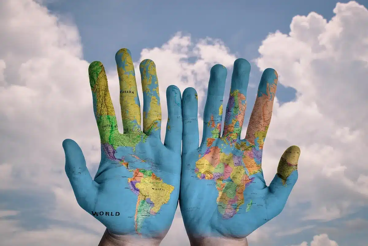 A world map with the US flag pattern overlaid across North America, Greenland, and the Caribbean, displayed on a digital screen with no identifying text or logos visible