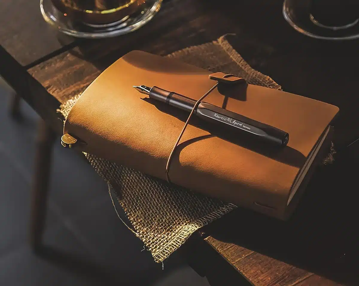 an empty desk with a generic envelope and a stack of unbranded documents, a pen resting nearby, soft indoor lighting