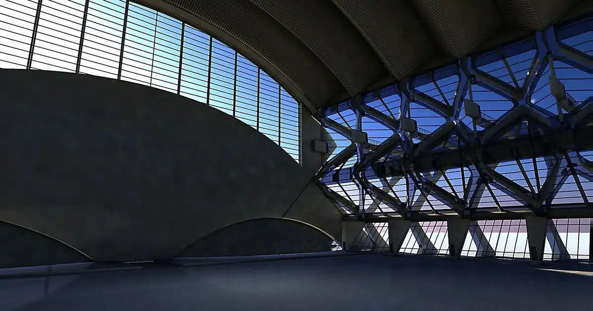 A dimly lit empty sports hall with one row of anonymous folding chairs and a single unbranded rugby ball on the floor, a faint banner shape out of focus in the distance