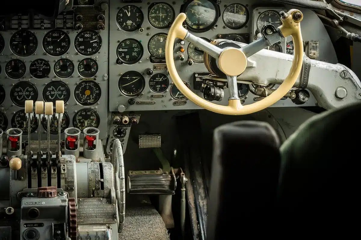 Cockpit instrument panel with hydraulic system gauges and warning lights illuminated, technical switches and displays