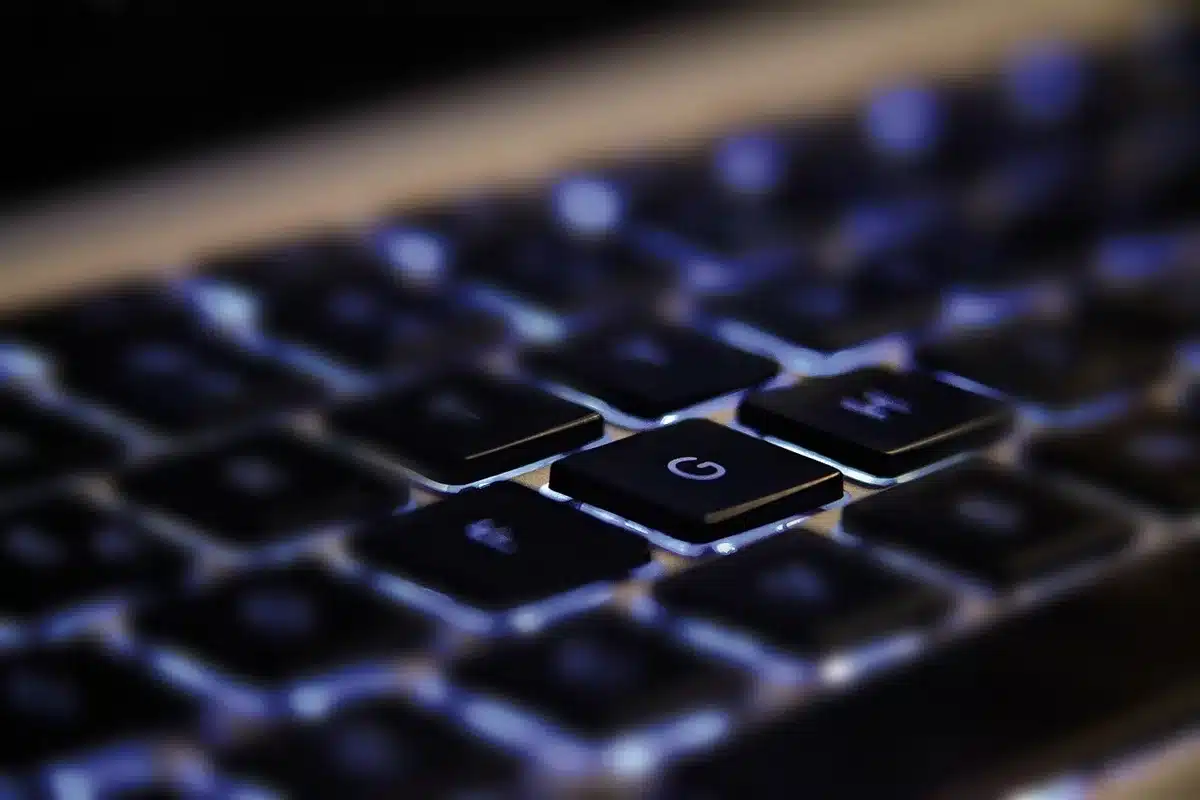 Close-up of an anonymous engineer's hands adjusting a generic GPU on a workbench, tools and circuit boards blurred in the background