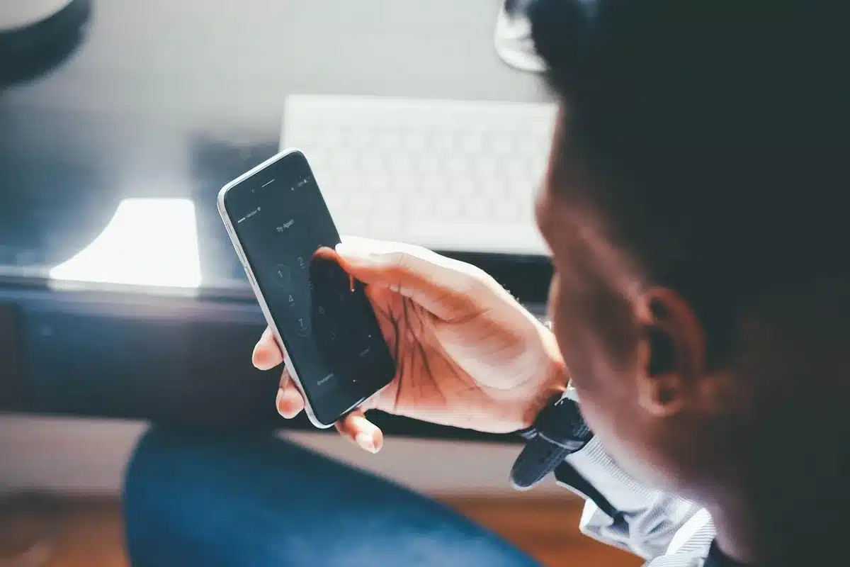 Close-up of a generic smartphone on a legal pad, a printed court filing blurred in the background, neutral desk setting, no logos