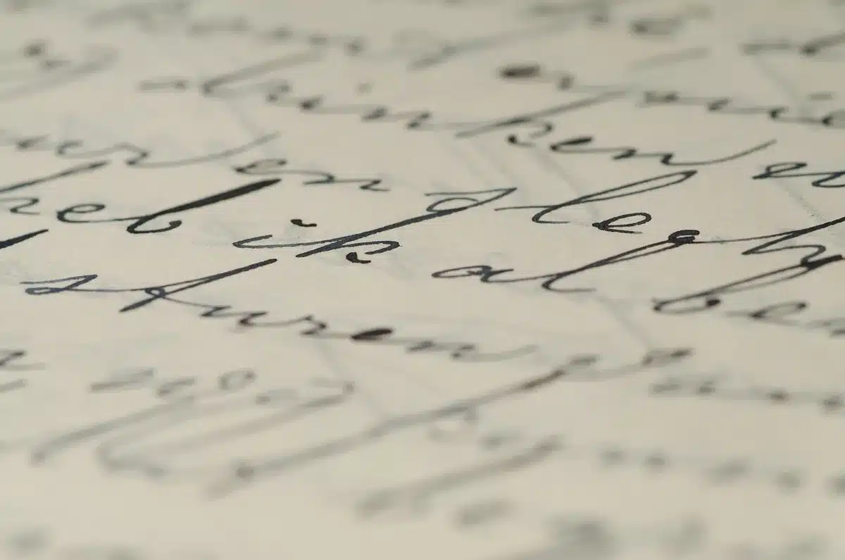 A close-up of a blank, official-looking document stamped but without readable text, a pen resting on its edge beside a pair of unpaid invoices
