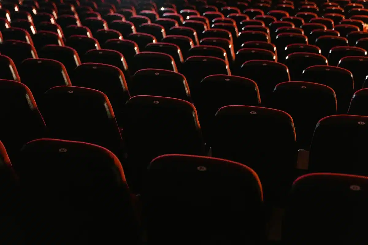 Empty auditorium with a single unbranded armchair under a spotlight, no people visible
