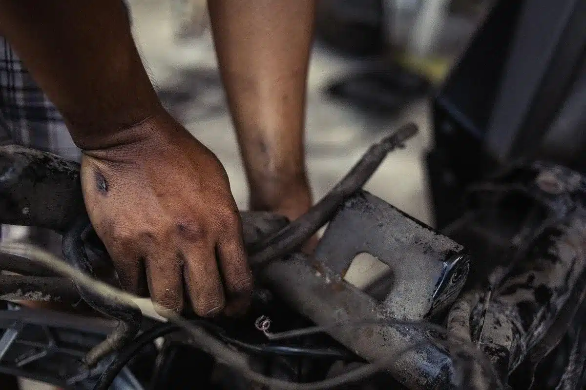 Close view of an anonymous technician’s hands adjusting an unbranded network cable in front of blurred rack-mounted DPUs and GPU modules, no logos visible; suggests infrastructure work to secure agentic AI