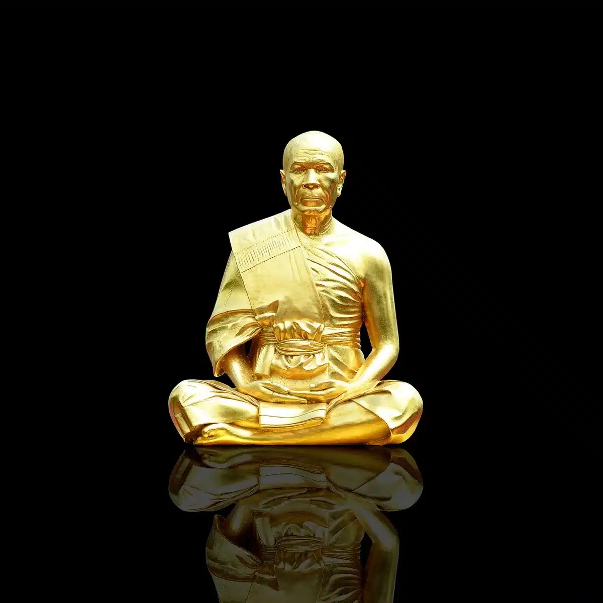 A wide museum interior showing a tall gold-covered sculpture on a plinth, anonymous visitors viewing from a respectful distance; no faces or logos visible